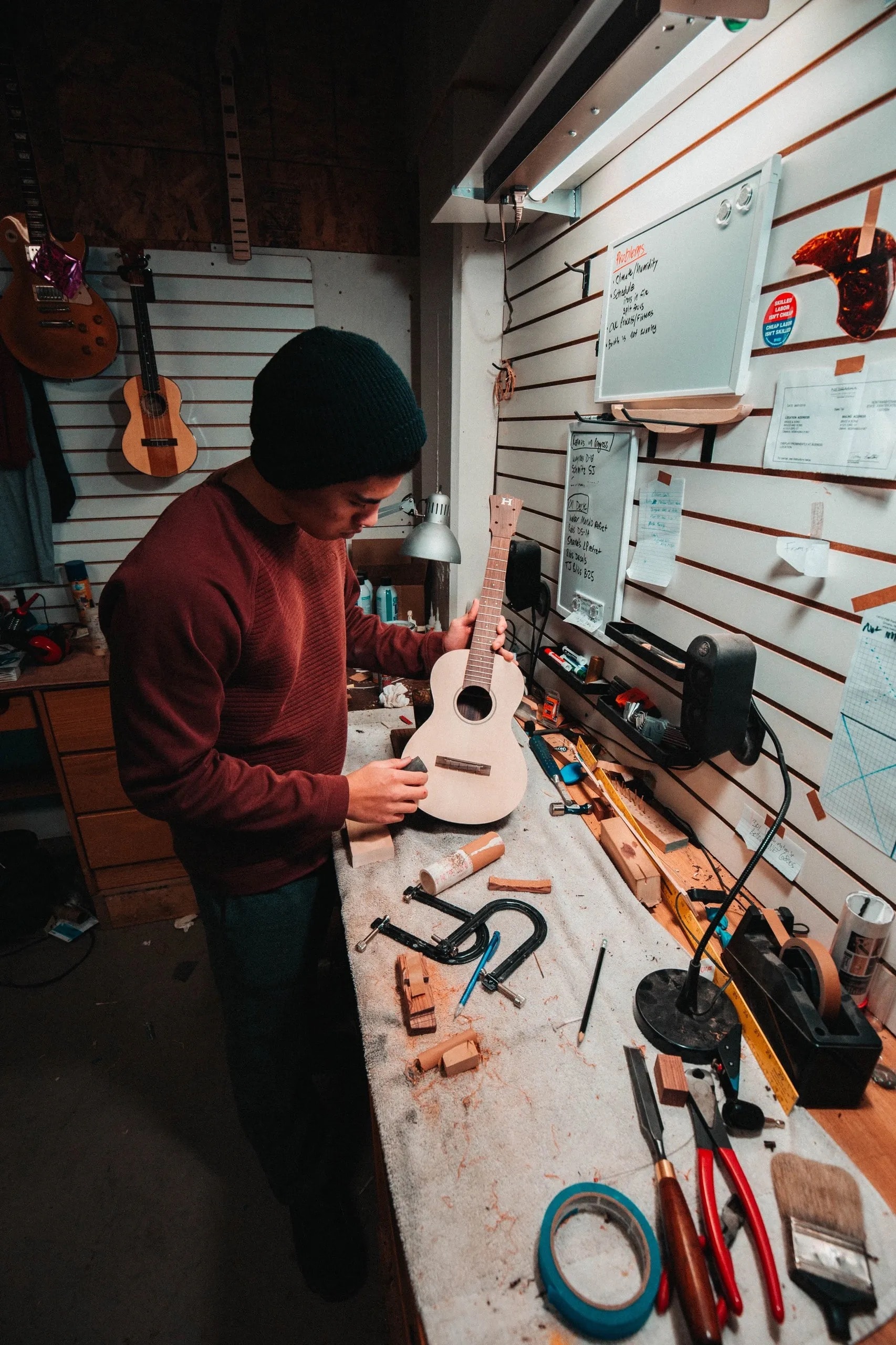 Luthier repairing an acoustic ukulele at the workbench